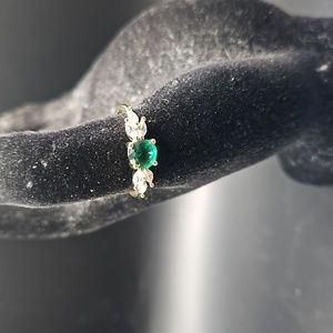 E-10 Silvertone ring with green ston and clear accents